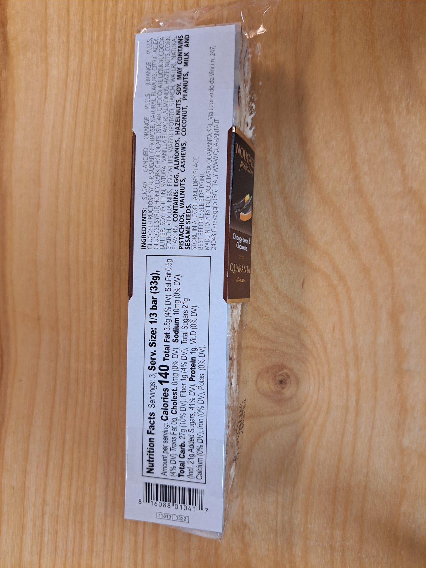 Bar of nougat with a label on a wooden surface