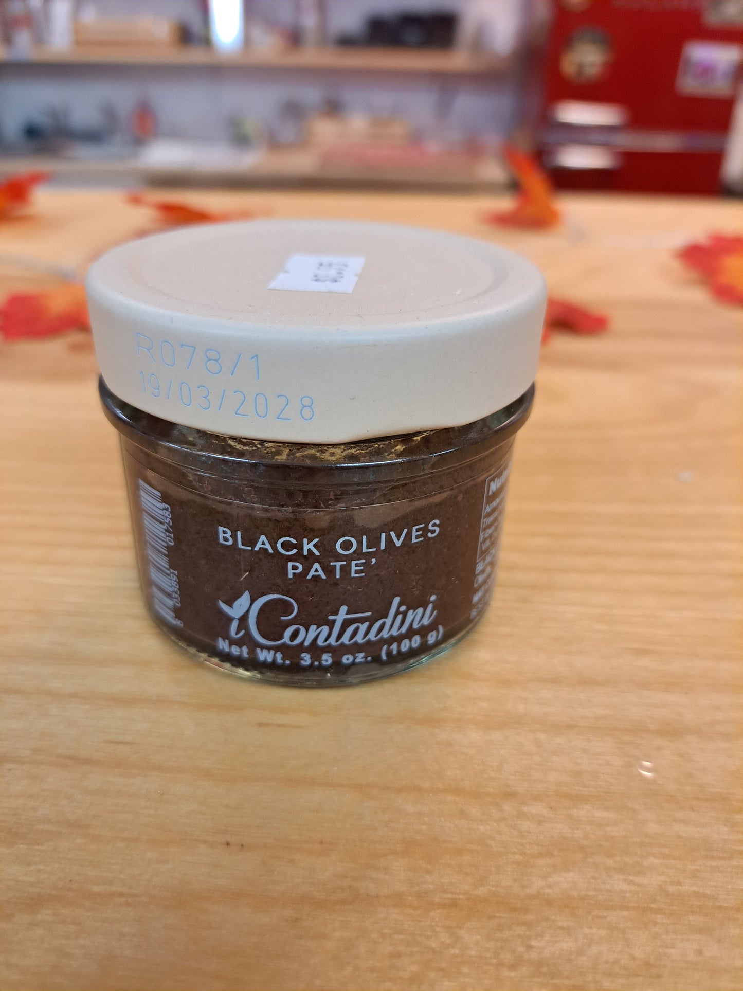 Jar of Contadini Black Olives Pate on a wooden surface