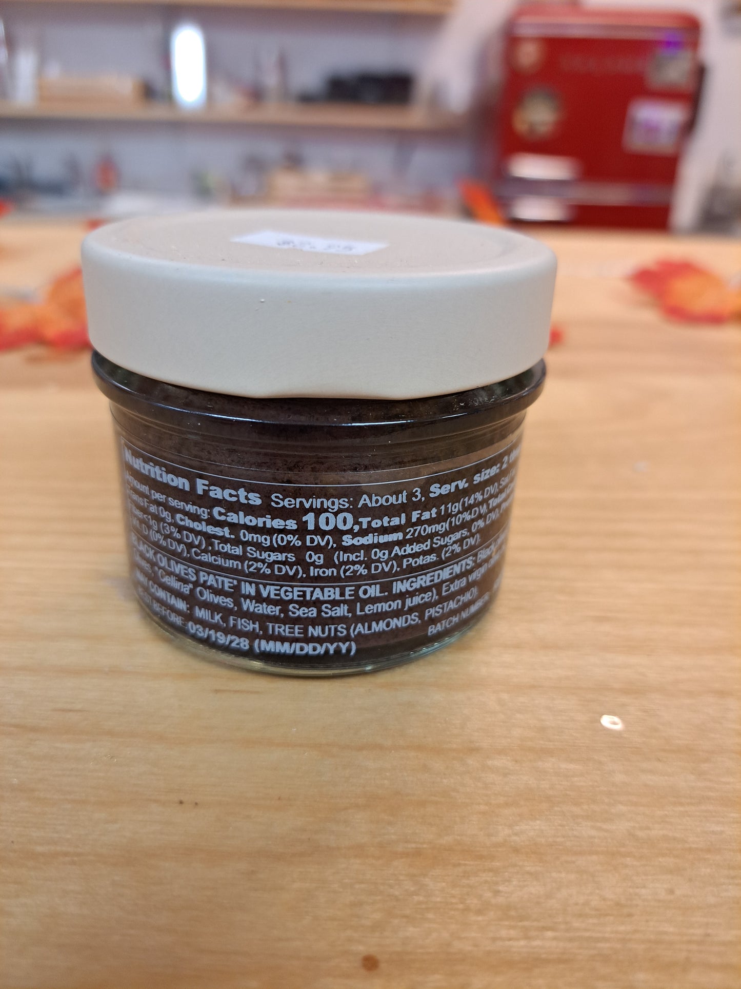 Jar of cream on a wooden surface with blurred background