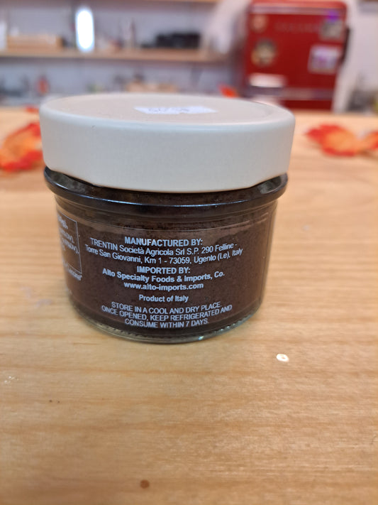 Jar of Nutella on a wooden surface with a blurred background