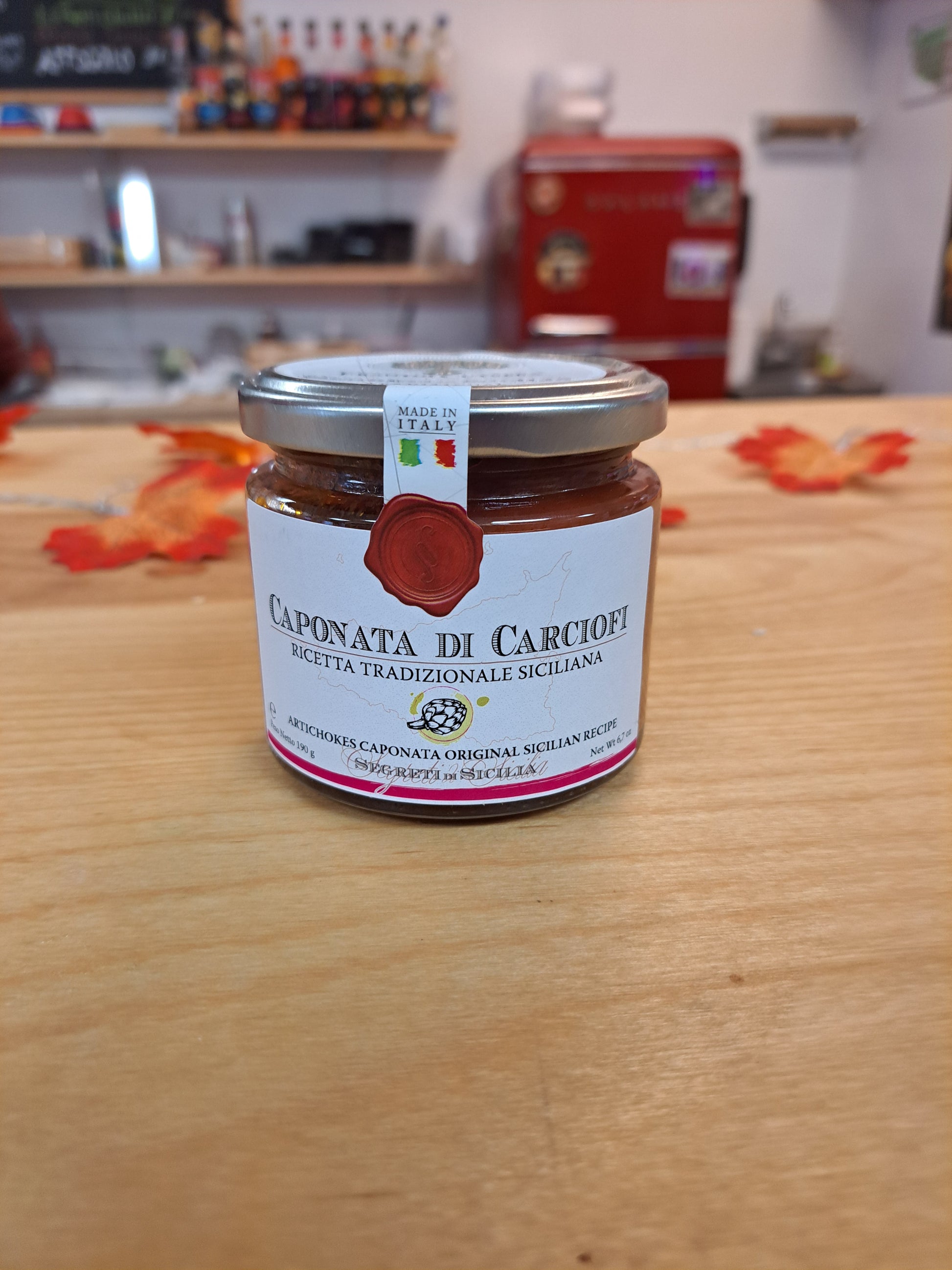 Caponata Di Carciofi jar on a wooden surface