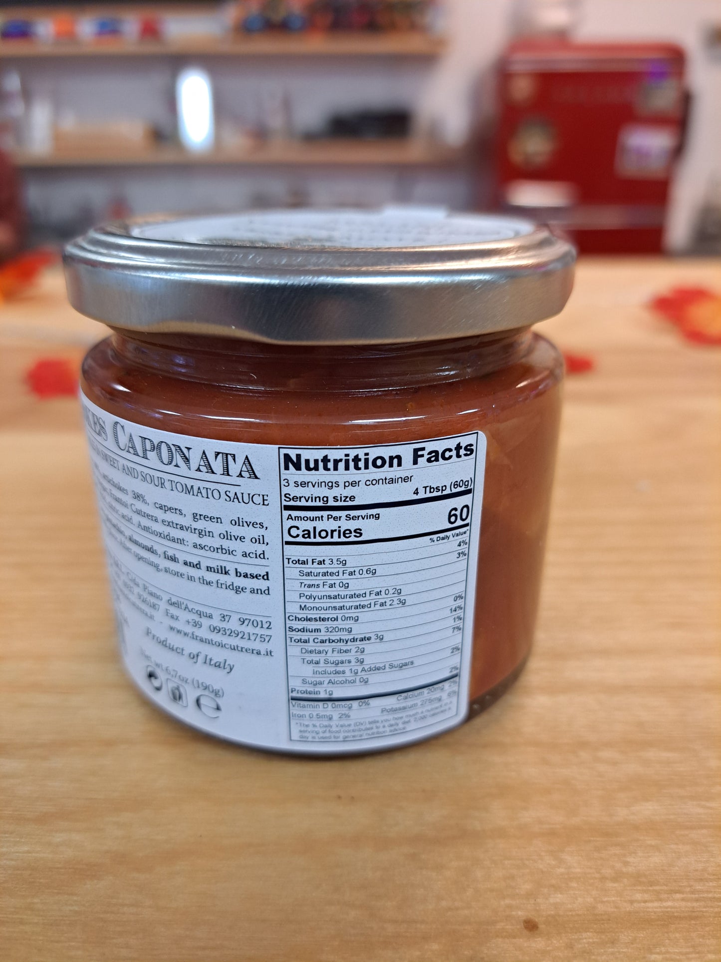 Jar of sauce with a label on a wooden surface