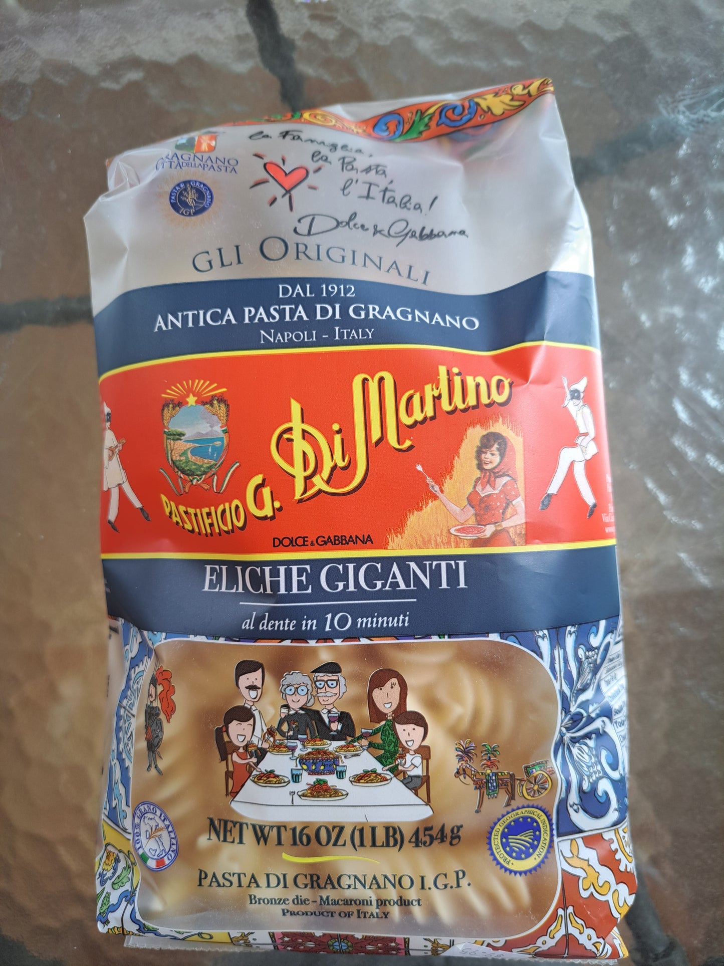 Pasta package with colorful design on a textured surface
