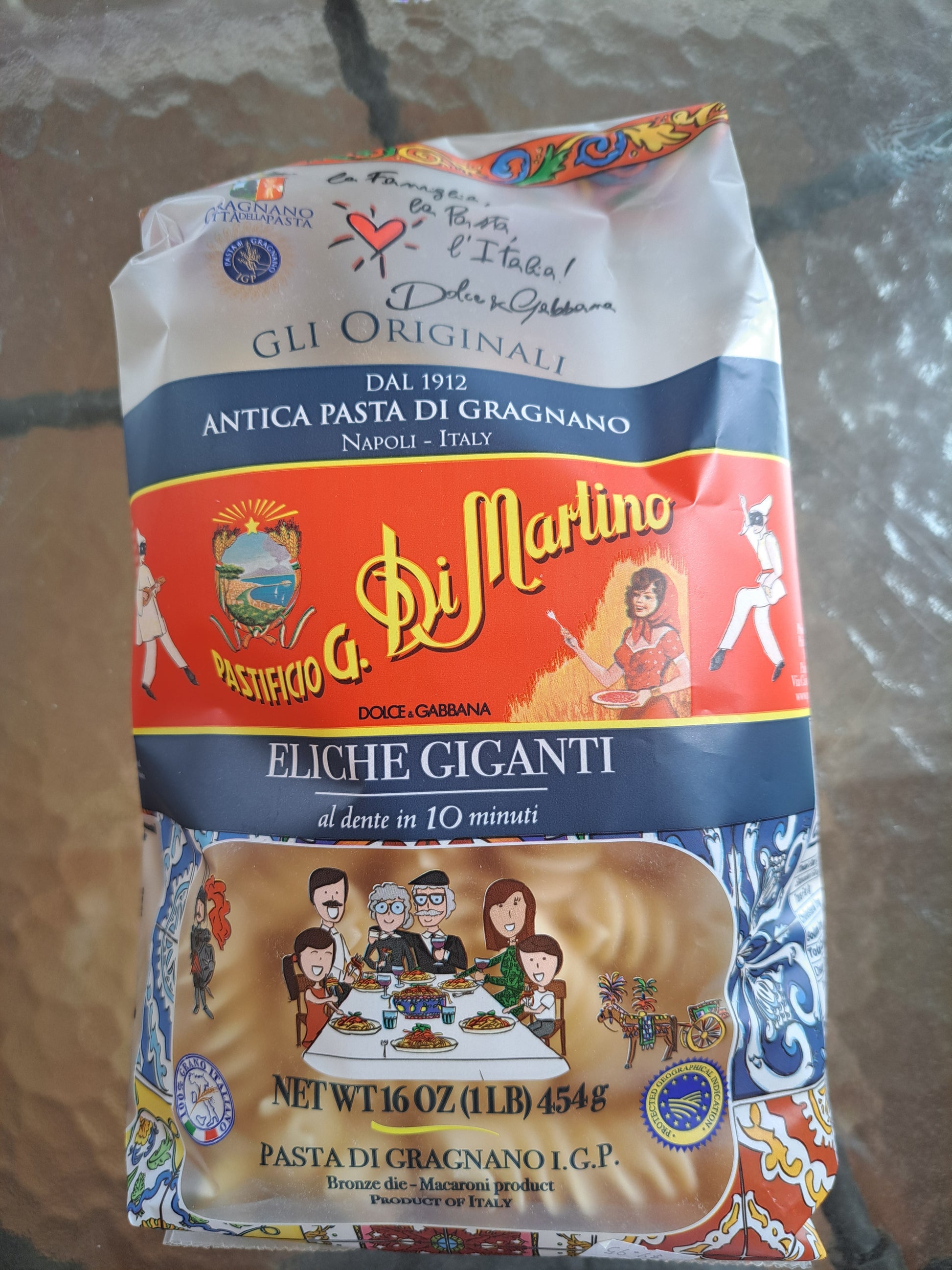 Pasta package with colorful design on a textured surface