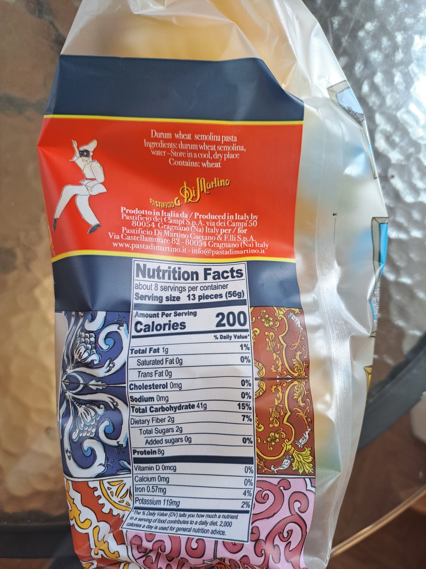 Packaged product with a colorful label featuring nutritional information on a reflective surface.