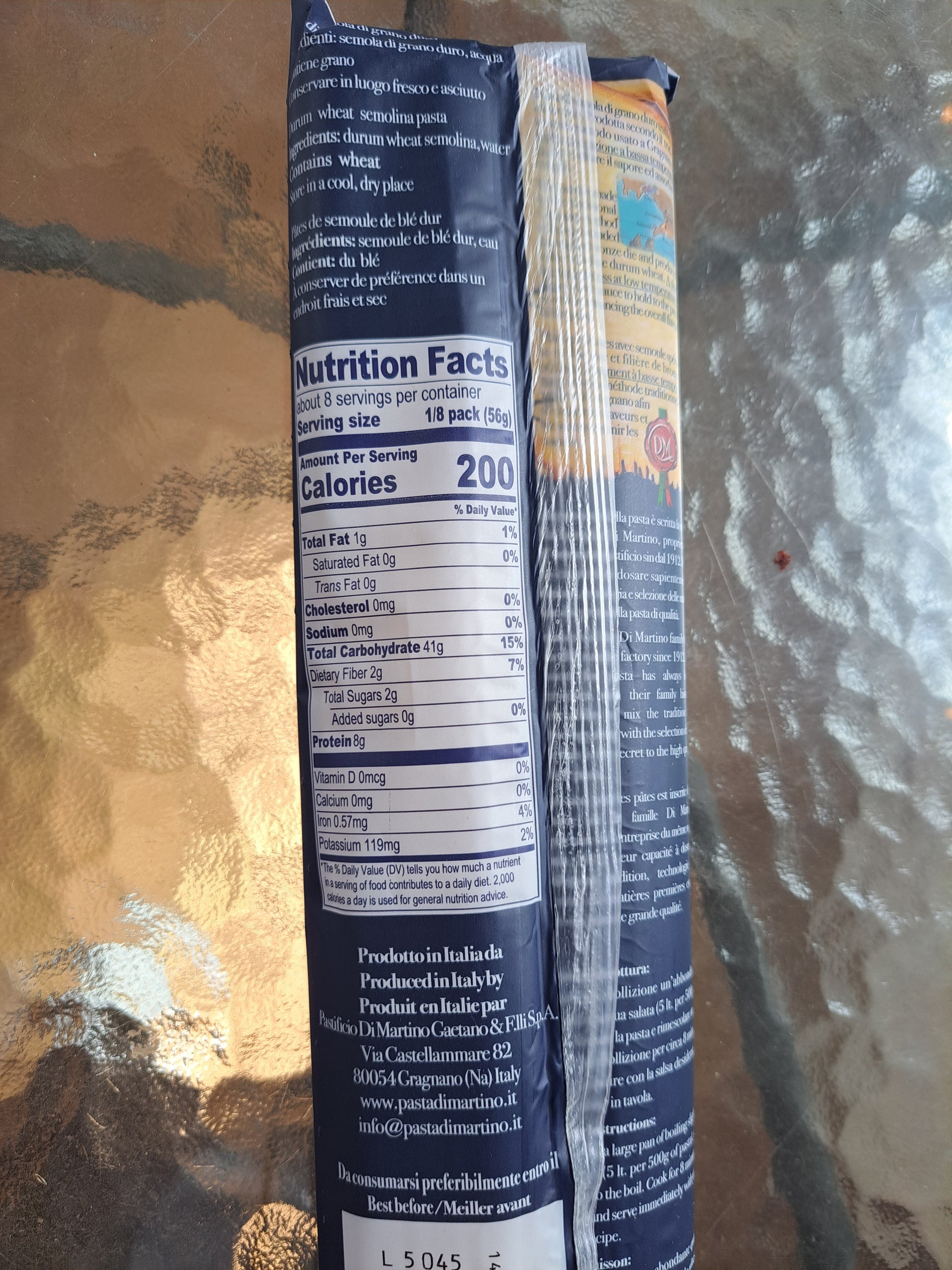 Close-up of a cylindrical product with a blue label on a reflective surface