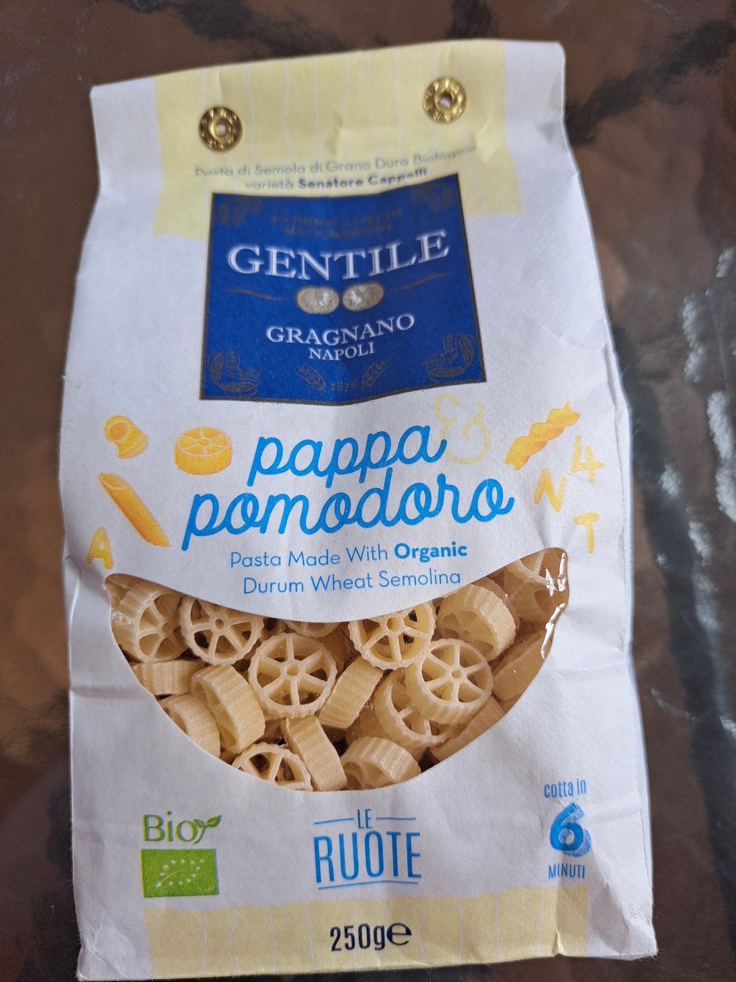 Gentile pasta package with 'Pappa Pomodoro' on a wooden surface