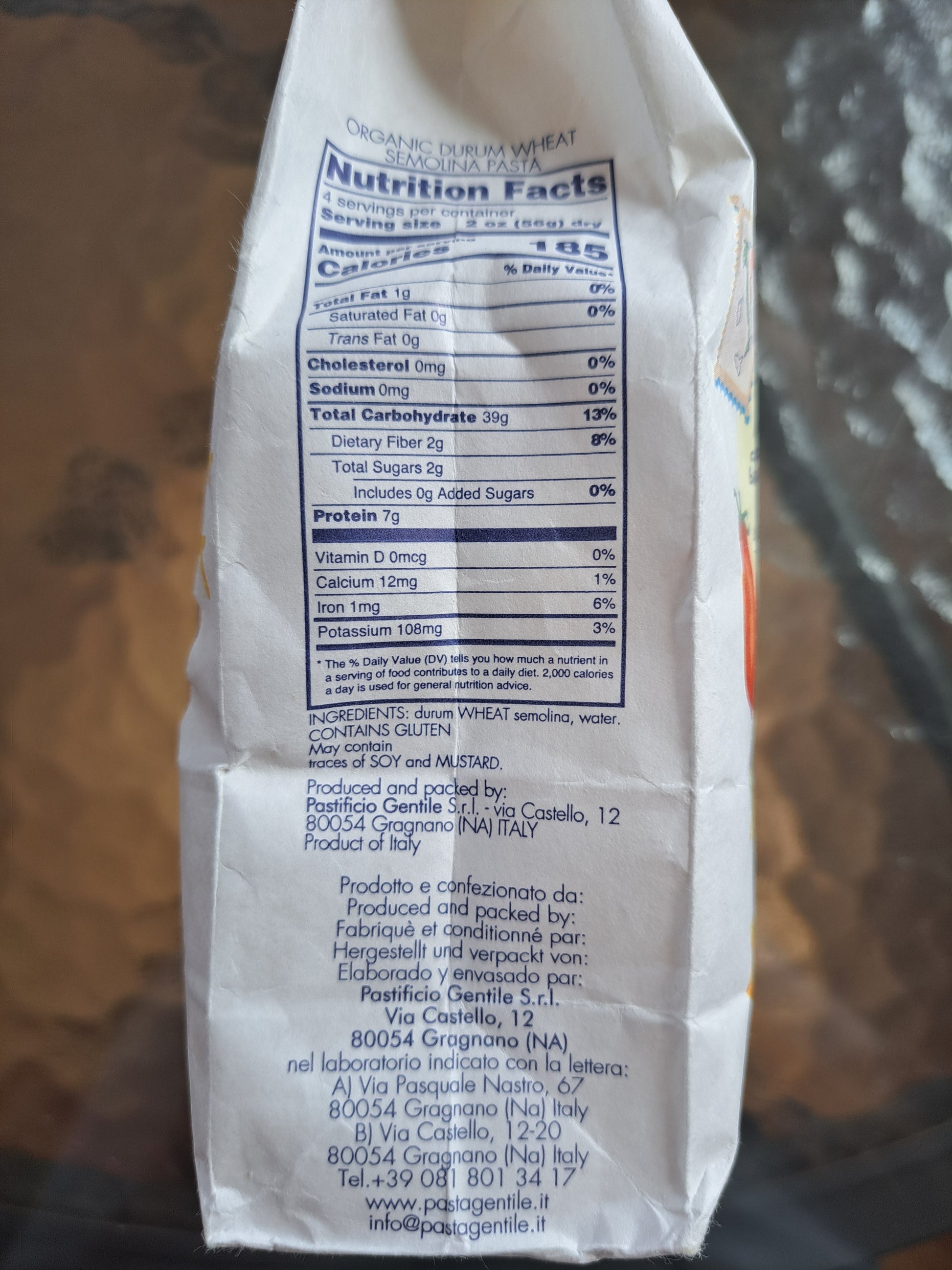 Close-up of a pasta package with nutrition facts label on a blurred background