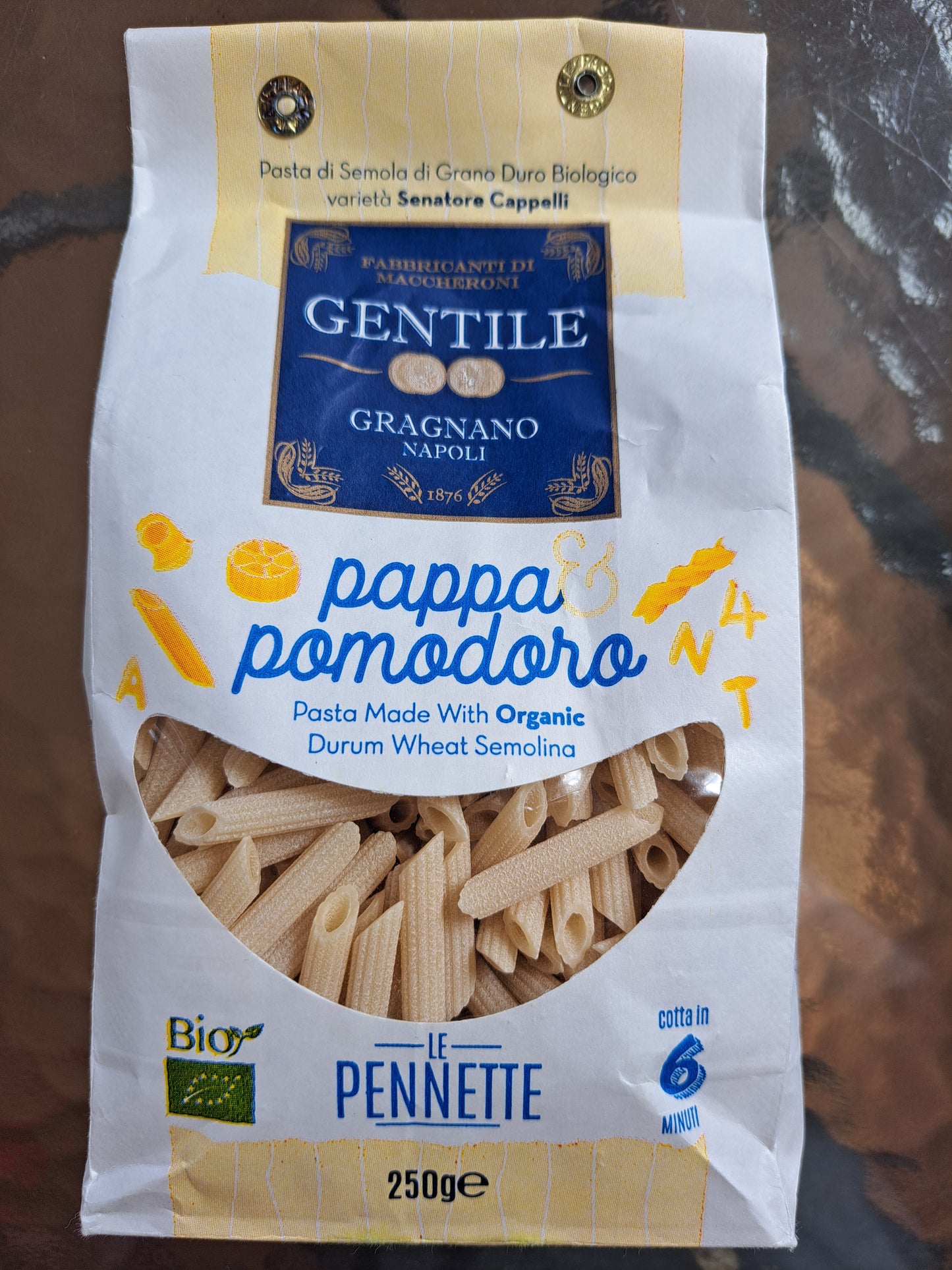 Pasta package with Gentile Gragnano Napoli branding on a reflective surface