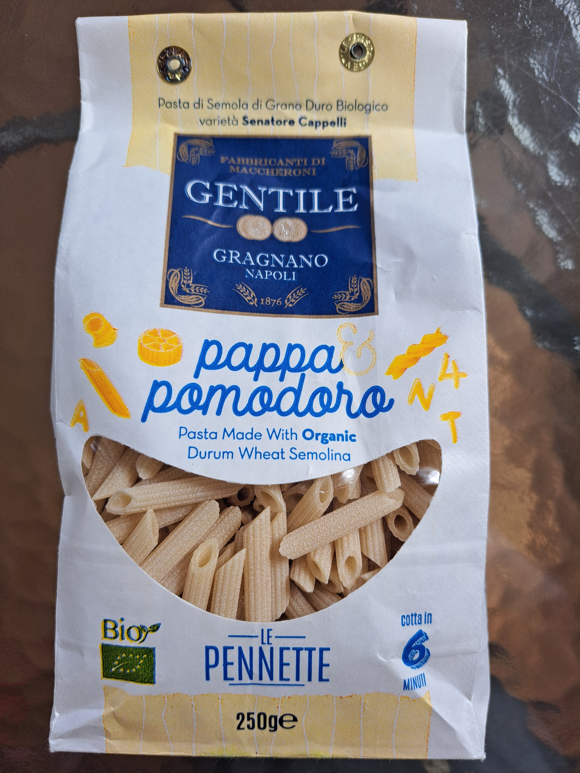 Pasta package with Gentile Gragnano Napoli branding on a reflective surface
