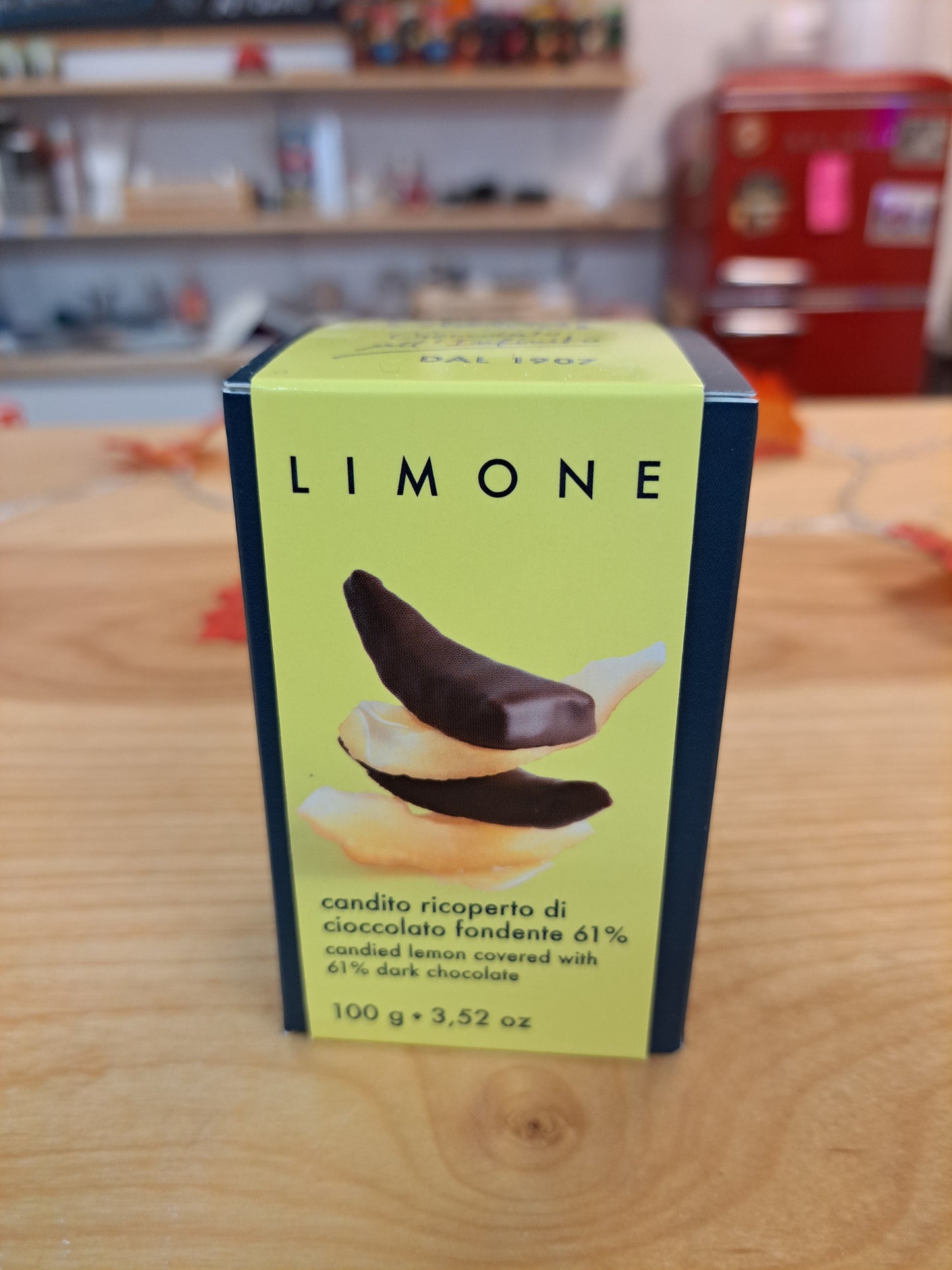 Box of Limone chocolate on a wooden surface with a blurred background