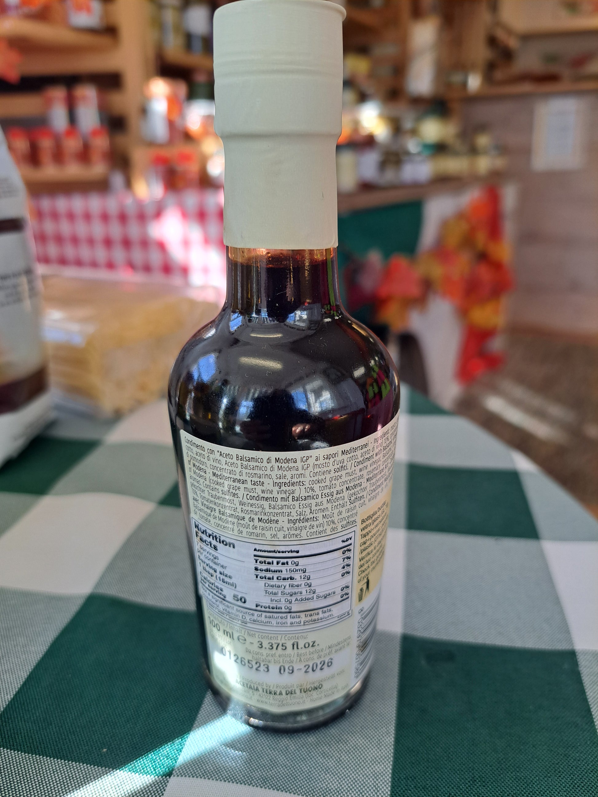 Bottle of alcohol on a checkered tablecloth with a blurred background