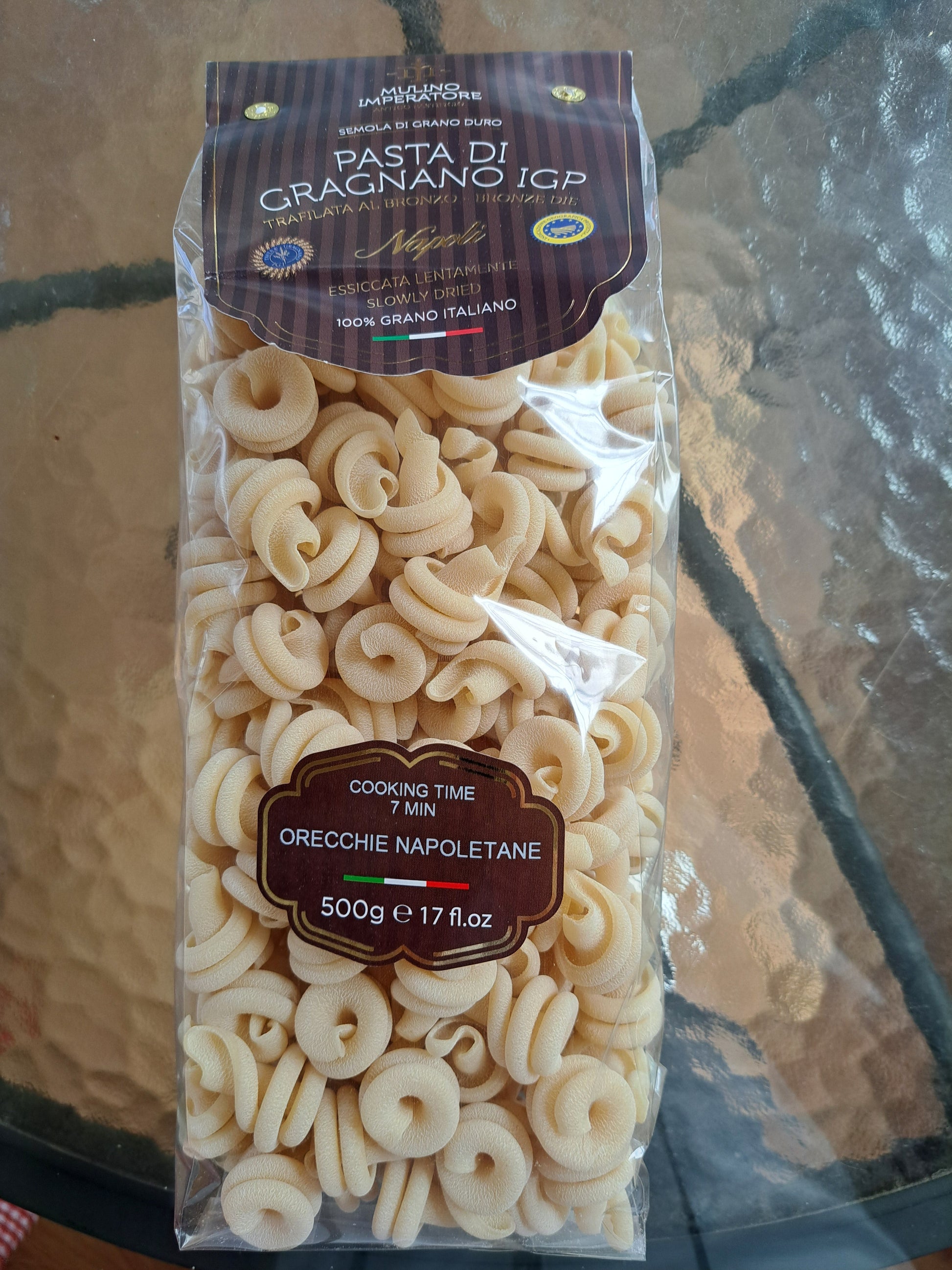 Packaged pasta with labels on a reflective surface