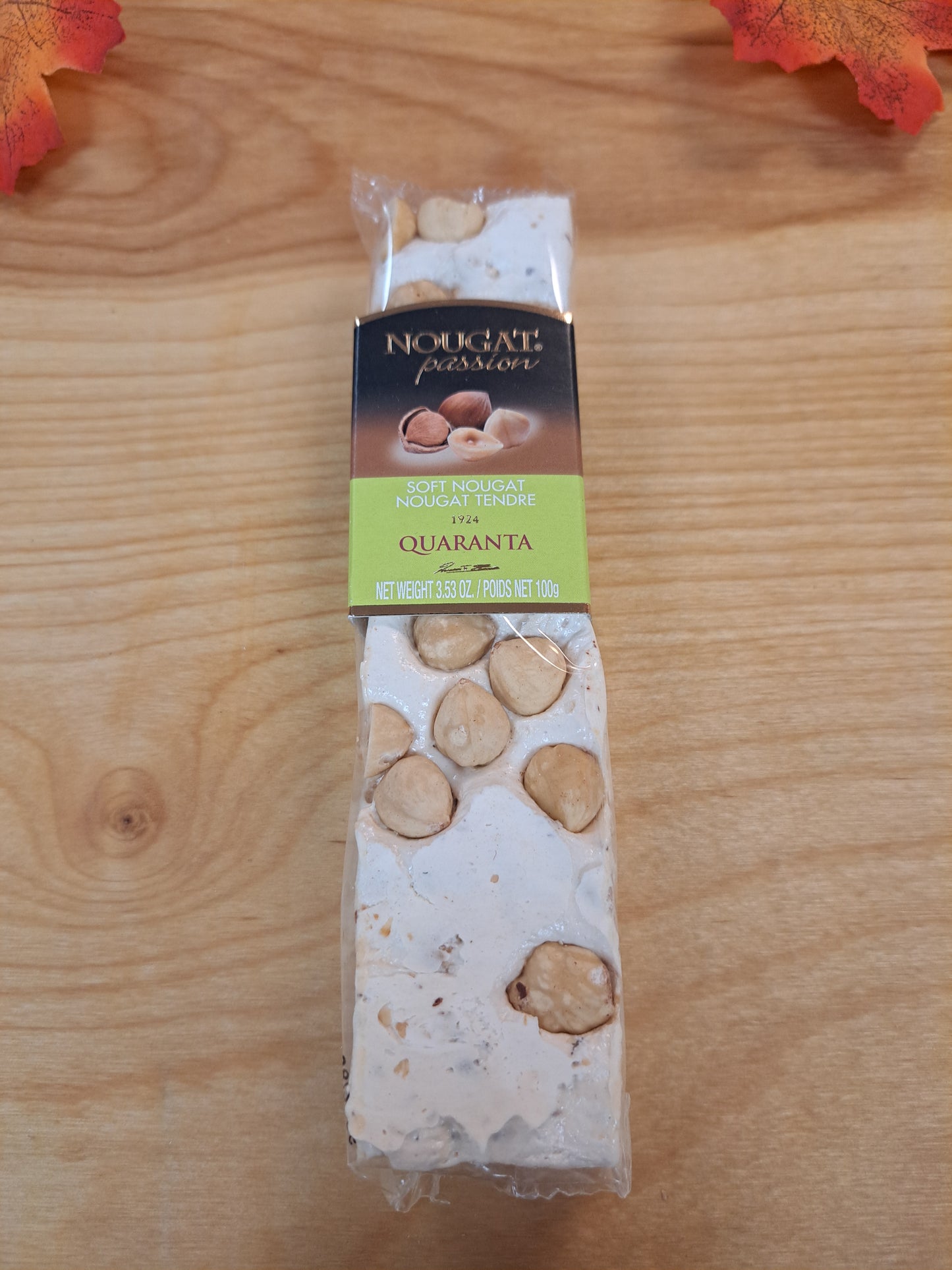 Packaged nougat bar with visible brand name on a wooden surface