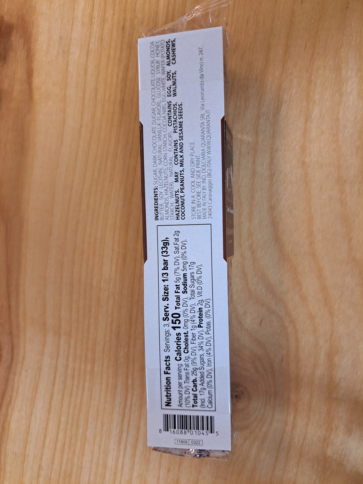 Product packaging with text and a barcode on a wooden surface