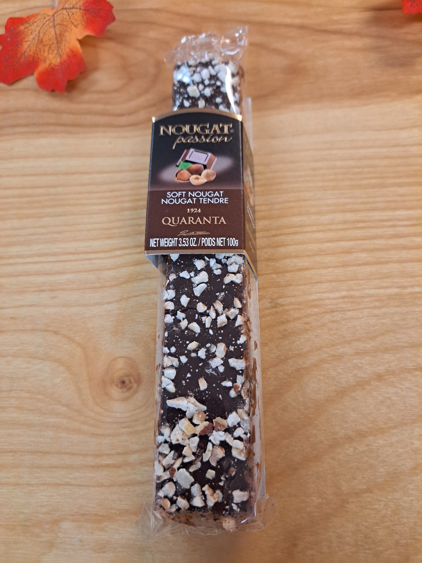 Packaged chocolate bar with visible brand name on a wooden surface