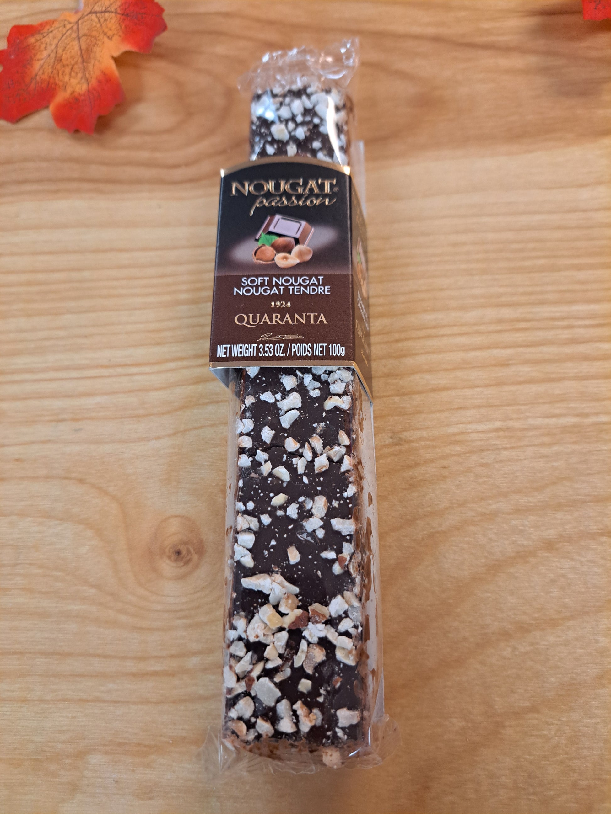 Packaged chocolate bar with visible brand name on a wooden surface