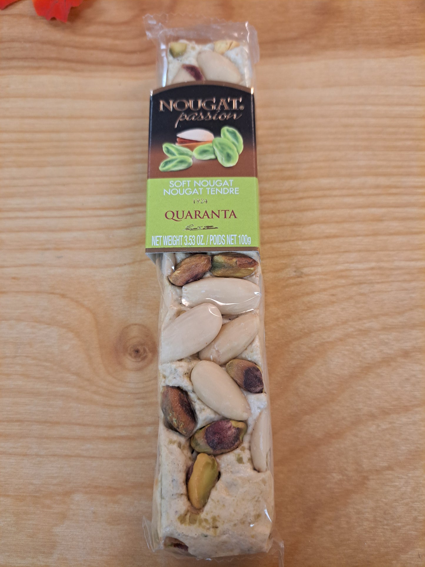 Packaged snack bar with visible ingredients on a wooden surface