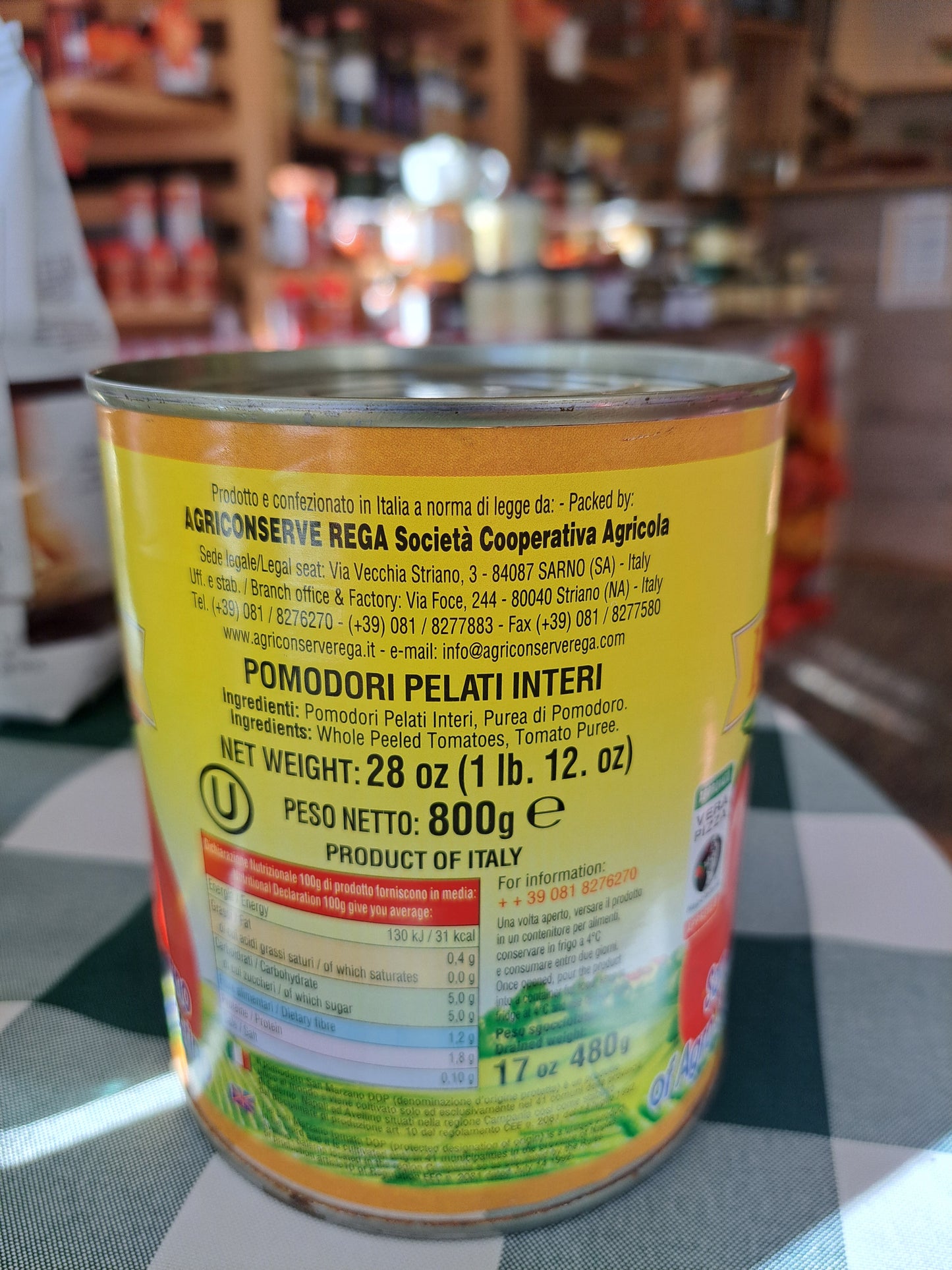 Can with yellow label on a checkered tablecloth