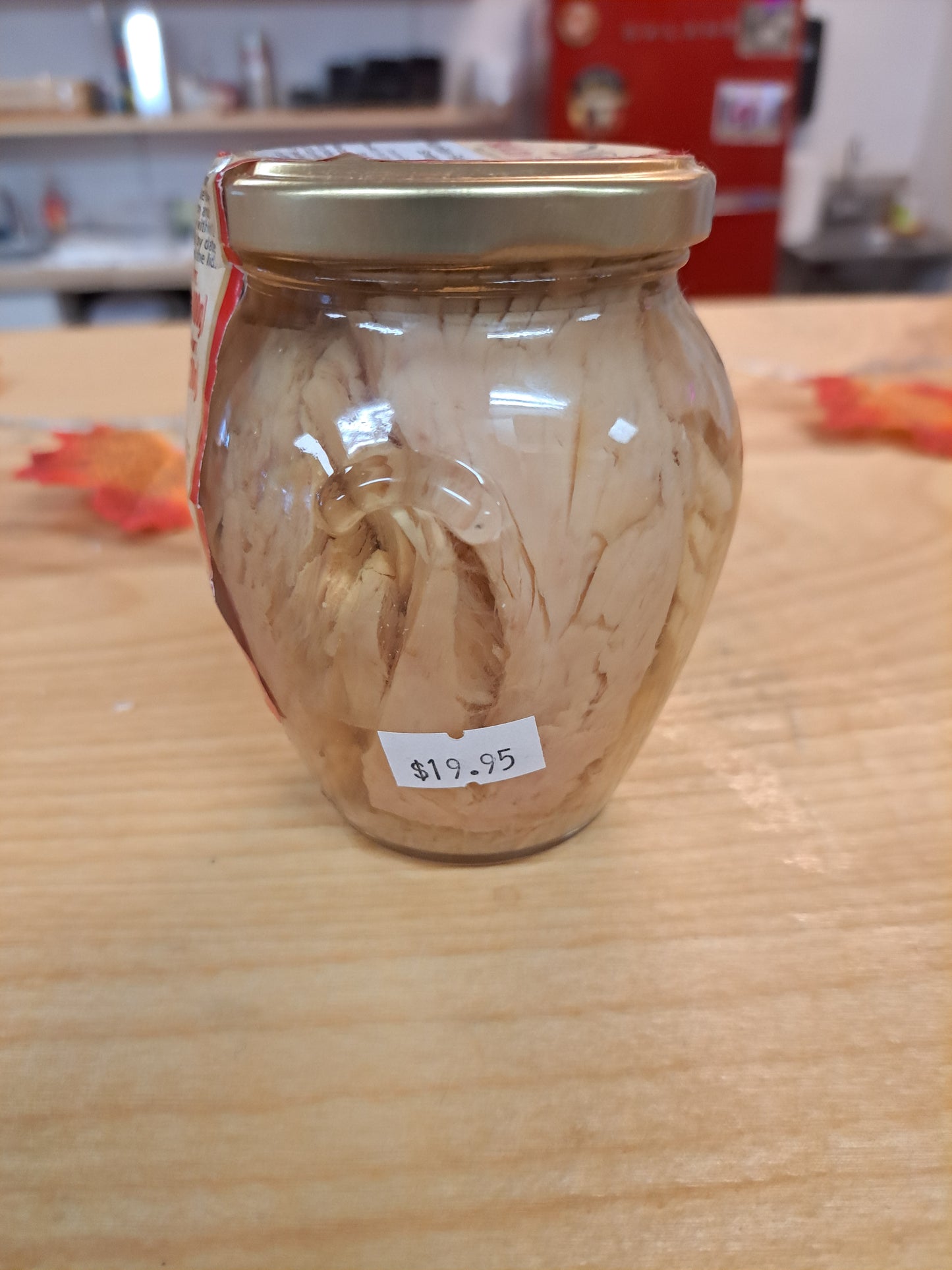 Jar of Solid Light Tuna with a price tag on a wooden surface