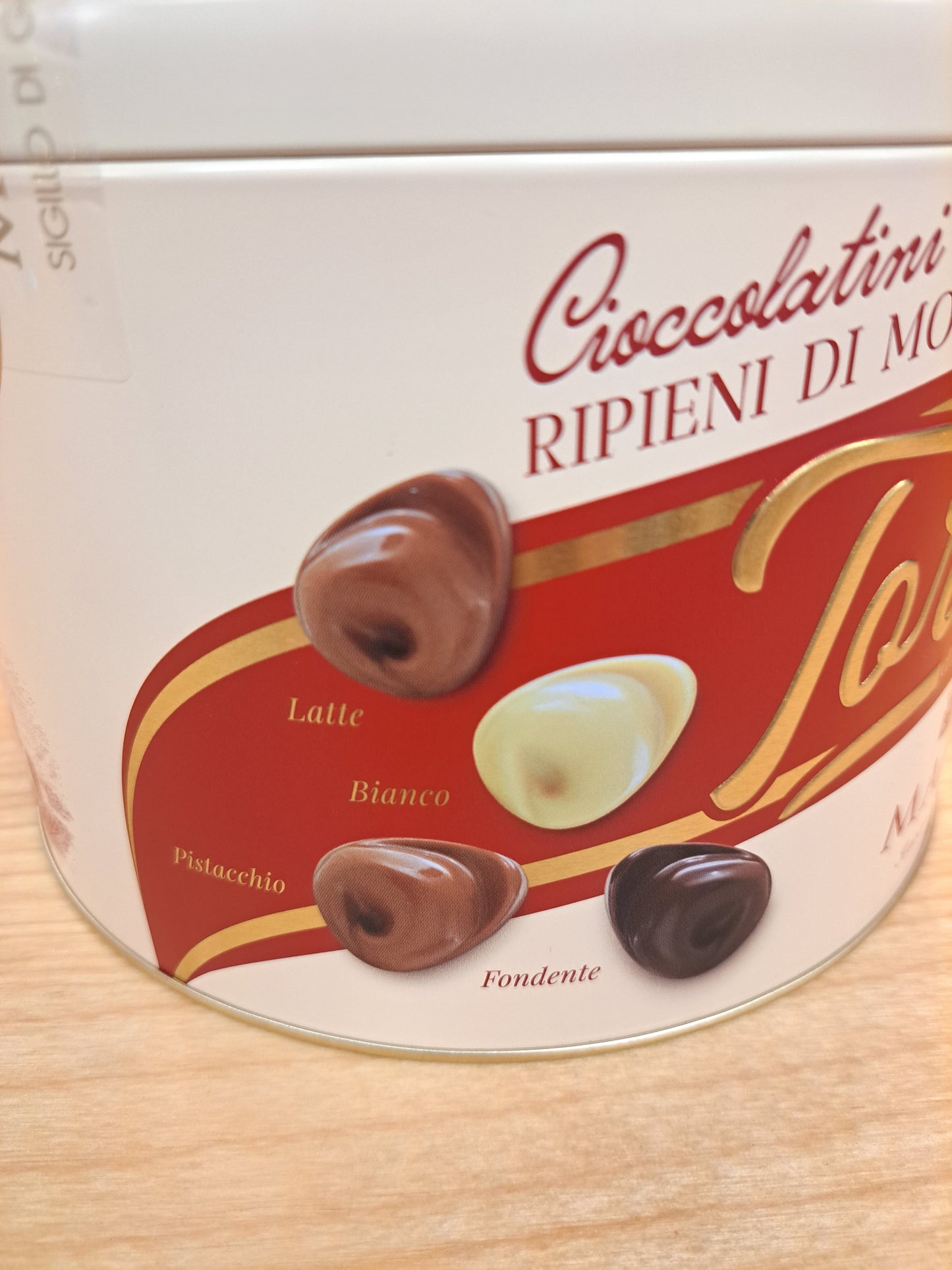 Box of Tortellino Majani Assorted Chocolates with a close-up of the packaging on a wooden surface