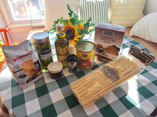 Pasta and various food items on a checkered tablecloth