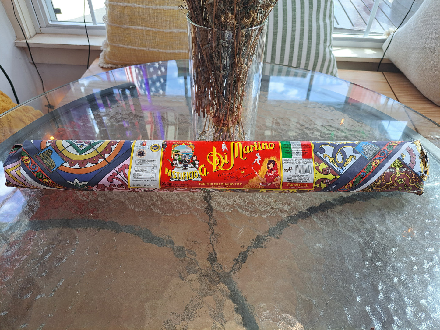 Roll of Di Martino pasta packaging on a glass table